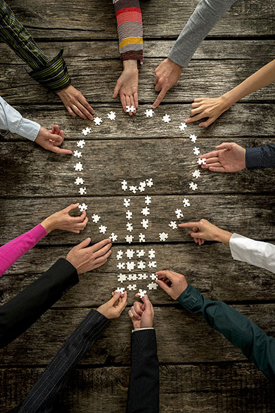 puzzle pieces form the shape of a light bulb